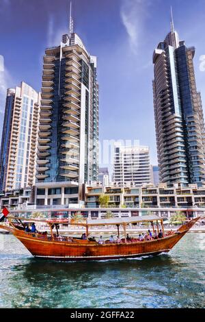 Dubai Marina with boats against skyscrapers in Dubai, United Arab Emirates Stock Photo