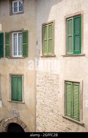 Citta Alta, Bergamo, Italy: typical street scene; tall palazzos with green shutters over windows on Piazza Rosate. Stock Photo