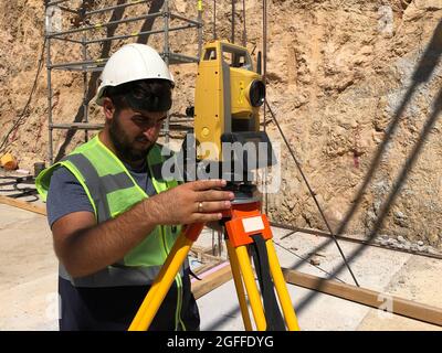 Land surveyor works at construction site Stock Photo