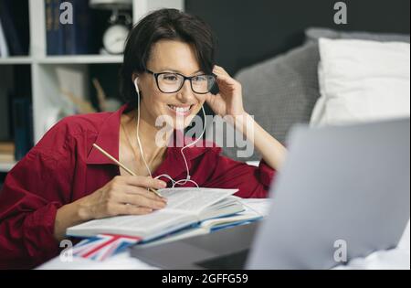 Woman using laptop for studying Stock Photo