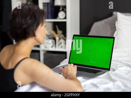 Woman with green screen laptop Stock Photo