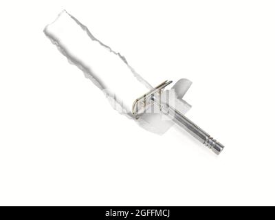 Vintage safety razor isolated on white background cuts and tears white paper. Stock Photo