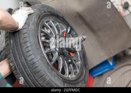 Wheel Balancing. Car wheel balance machine in auto repair Stock Photo