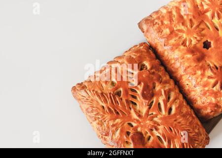 Homemade baked pies with mushrooms and berry cake cooling on cloth with copy space. Flat lay, top view Stock Photo