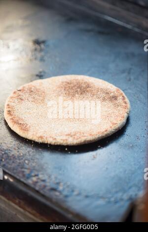 Moroccan whole wheat flatbread on grill pan Stock Photo