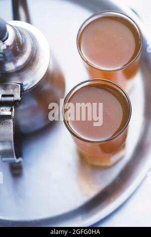 Moroccan tea, kettle and glass of fresh tea, Essaouira, Morocco Stock Photo