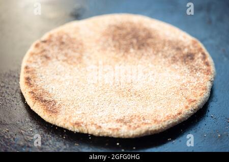 Moroccan whole wheat flatbread on grill pan Stock Photo