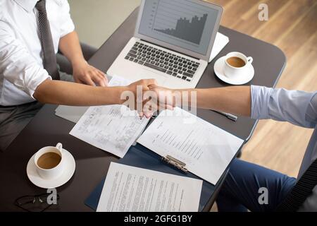 Confident businessmen shaking hands Stock Photo