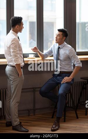 Confident businessmen talking in café Stock Photo
