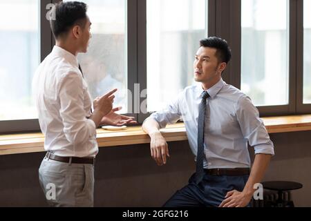 Confident businessmen talking in café Stock Photo