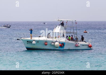 COZUMEL, MEXICO -AUGUST 25, 2021: A tourist information worker give travel  adventures info to tourist that enjoy their holidays in Cozumel island amid  the fourth upturn of Covid-19 disease on August 25,