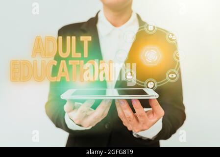 Text sign showing Adult Education. Conceptual photo educational programs for adults who are out of school Lady In Uniform Holding Phone And Showing Stock Photo