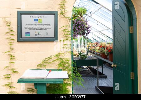 Ardencraig Gardens - visitor book at the entrance to one of the greenhouses - Rothesay, Isle of Bute, Argyll and Bute, Scotland, UK Stock Photo