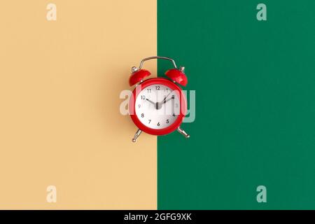 Red alarm clock on color background Stock Photo