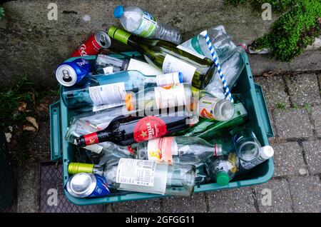 Glass and plastic bottle left outside on the pavement to be collected for recycling. Stock Photo