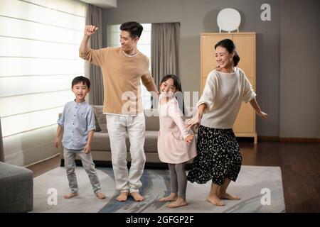 Happy young family having fun in living room Stock Photo