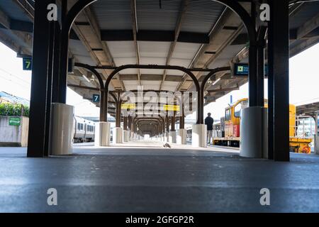 Wellington New Zealand - July 31 2021; Train station platform long interior shadows with people moving through. Stock Photo