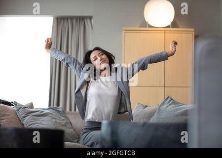 Young businesswoman relaxing on sofa Stock Photo