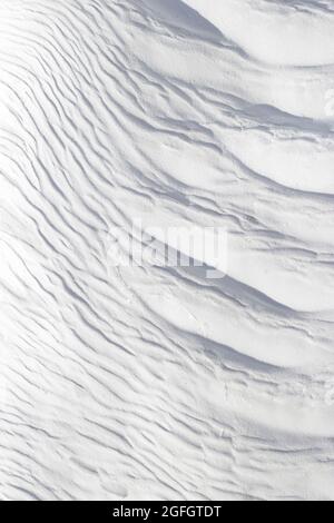 Textured effect of waves on surface of gray and white stone. Pamukkale travertine surface in Turkey. Stock Photo