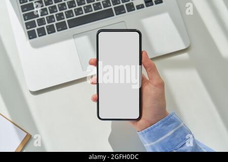 Faceless woman using smartphone with empty screen. Mockup, flat lay, copy space, template Stock Photo