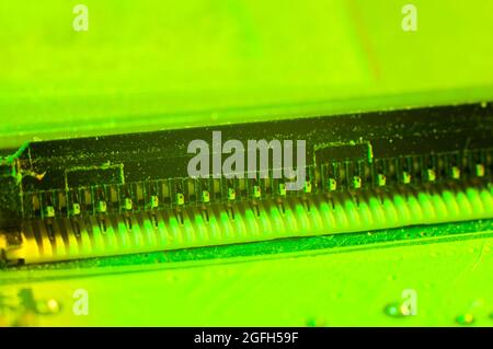 Pins for connecting to printed circuit board close-up in green light Stock Photo
