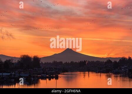 Colorful sunrise sky over Mt Hood and tranquil reflective river in Portland, Oregon, Pacific Northwest United States Stock Photo