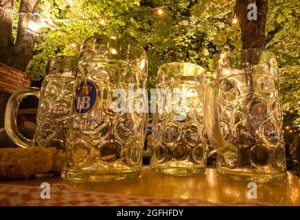 Munich, Germany. 25th Aug, 2021. Empty beer mugs stand on a beer bench at Wiener Platz. Credit: Peter Kneffel/dpa/Alamy Live News Stock Photo