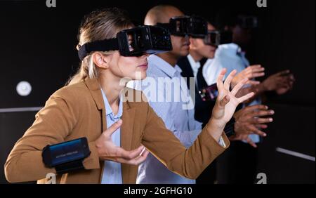 Woman using virtual reality headset and gesturing Stock Photo