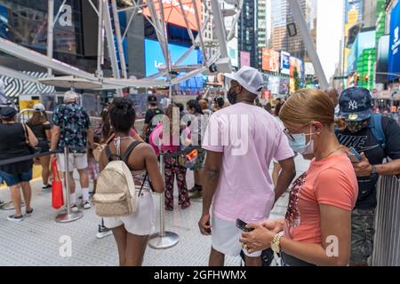 New York, United States. 25th Aug, 2021. People wait to ride the Times Square Ferris wheel on opening day in Times Square, New York City.The 110-foot Times Square Ferris Wheel, located on Broadway between 47th and 48th street, will be open until September 14th, 2021. Credit: SOPA Images Limited/Alamy Live News Stock Photo