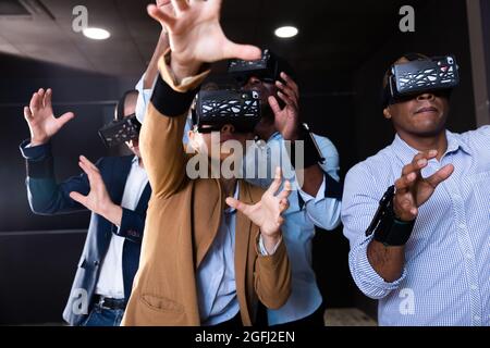 People using virtual reality headset and gesturing Stock Photo