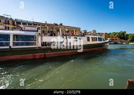 Actv (municipal company for public transport) Ferry Boat or Vaporetto crowded with tourists in motion in the Venice Lagoon, Grand Canal. Veneto, Italy Stock Photo
