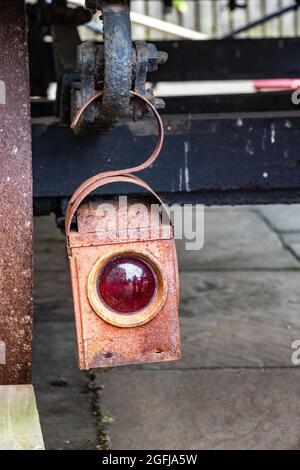 old green ham or Kenyon hanging road works lantern hanging on trailer Stock Photo