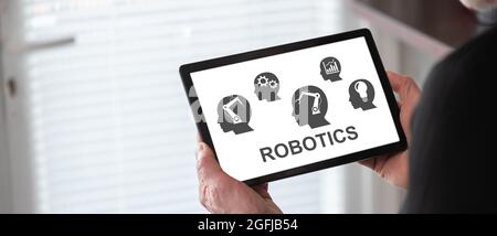 Robotics concept shown on a tablet held by a man Stock Photo