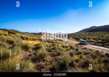 Landscape of the coastal area Cabo de Gata, province of Almeria, Andalucia, Spain. RV on a dirt track in the Tabernas Desert Stock Photo