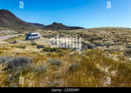 Landscape of the coastal area Cabo de Gata, province of Almeria, Andalucia, Spain. RV parked on the roadside in the Tabernas Desert Stock Photo