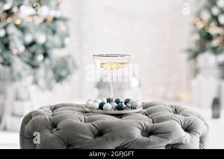 Happy New Year 2021. Christmas and New Year holidays minimal background, winter season. A glass of champagne against a background of bokeh lights. Sof Stock Photo