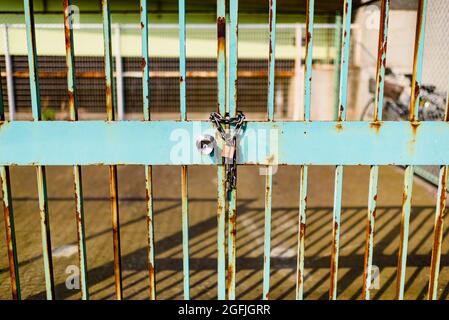 Old and rusty lock and metal gate Stock Photo