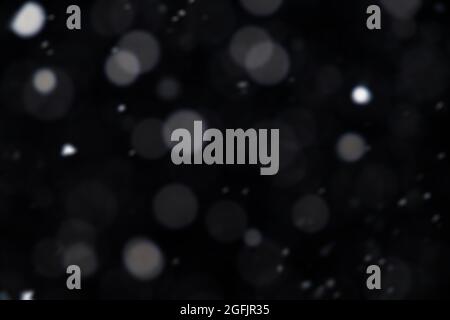 White bokeh circles on black background for overlay blending mode. Stock Photo