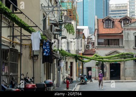 Shanghai, Shanghai, China. 26th Aug, 2021. On August 26, 2021, on both sides of Jiangyin Road in Huangpu District, Shanghai, there are mostly two-story Shikumen Lane houses. There are a lot of green vines along the outer wall of the street, which is nothing special at first glance. Observing carefully, these green leaves are actually simulated leaves with some wires that cannot be hidden inside. Compared with the black wires, this decoration looks much more beautiful. Visual pollution of various overhead lines in old communities is often difficult to deal with. However, in the blocks of Stock Photo