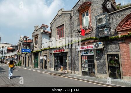 Shanghai, Shanghai, China. 26th Aug, 2021. On August 26, 2021, on both sides of Jiangyin Road in Huangpu District, Shanghai, there are mostly two-story Shikumen Lane houses. There are a lot of green vines along the outer wall of the street, which is nothing special at first glance. Observing carefully, these green leaves are actually simulated leaves with some wires that cannot be hidden inside. Compared with the black wires, this decoration looks much more beautiful. Visual pollution of various overhead lines in old communities is often difficult to deal with. However, in the blocks of Stock Photo