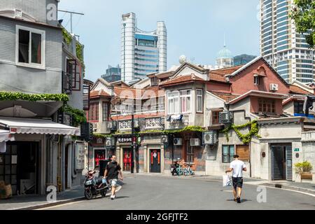Shanghai, Shanghai, China. 26th Aug, 2021. On August 26, 2021, on both sides of Jiangyin Road in Huangpu District, Shanghai, there are mostly two-story Shikumen Lane houses. There are a lot of green vines along the outer wall of the street, which is nothing special at first glance. Observing carefully, these green leaves are actually simulated leaves with some wires that cannot be hidden inside. Compared with the black wires, this decoration looks much more beautiful. Visual pollution of various overhead lines in old communities is often difficult to deal with. However, in the blocks of Stock Photo