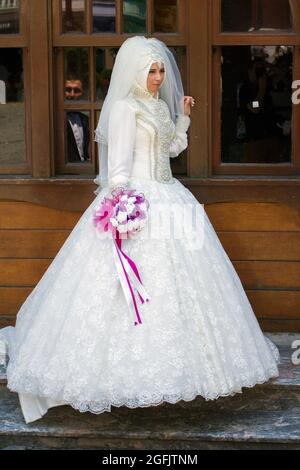 Istanbul, Turkey - June 8, 2014: Muslim bride at the Ortakoy Mosque in Istanbul on a summer day. Stock Photo