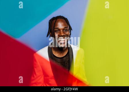 Artistic portrait with gel lights. Handsome man posing on colored backgrounds Stock Photo