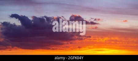 Dramatic colorful red orange to dark blue sunset or sunrise sky landscape clouds. Natural beautiful cloudscape dawn background wallpaper. wide banner Stock Photo