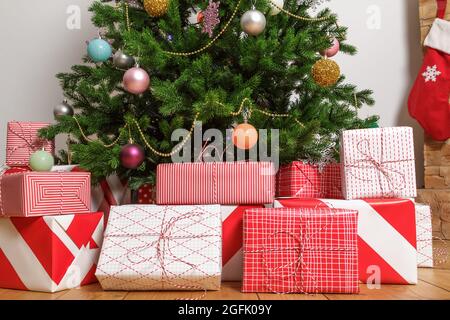 Close-up of christmas gift boxes under a tree Stock Photo