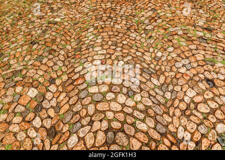 Old street in a medieval district. Cobblestone pattern. Stock Photo