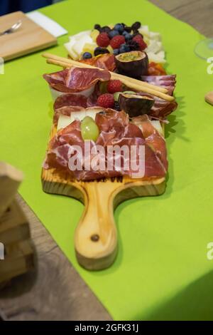 Portuguese mixed board of cheese and ham served with fruits Stock Photo
