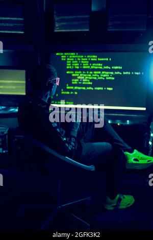 Cyber hacker breaks into databases to obtain information using a computer. Cybercrime and data security concept. Stock Photo