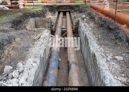 Repair work to replace the rusty pipes of the old water supply system with a new one Stock Photo