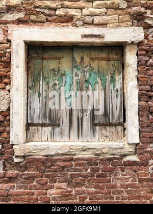 closed window blinds of an old brick house Stock Photo